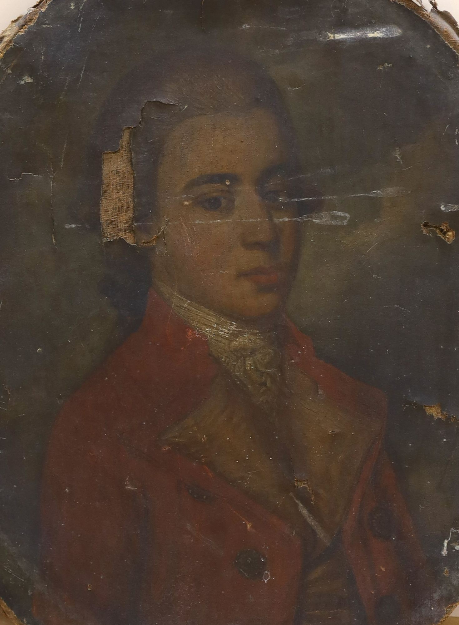 Late 18th century English School, oil on canvas, Portrait of a gentleman wearing a red coat, oval, 65 x 54cm, unframed (a.f.)